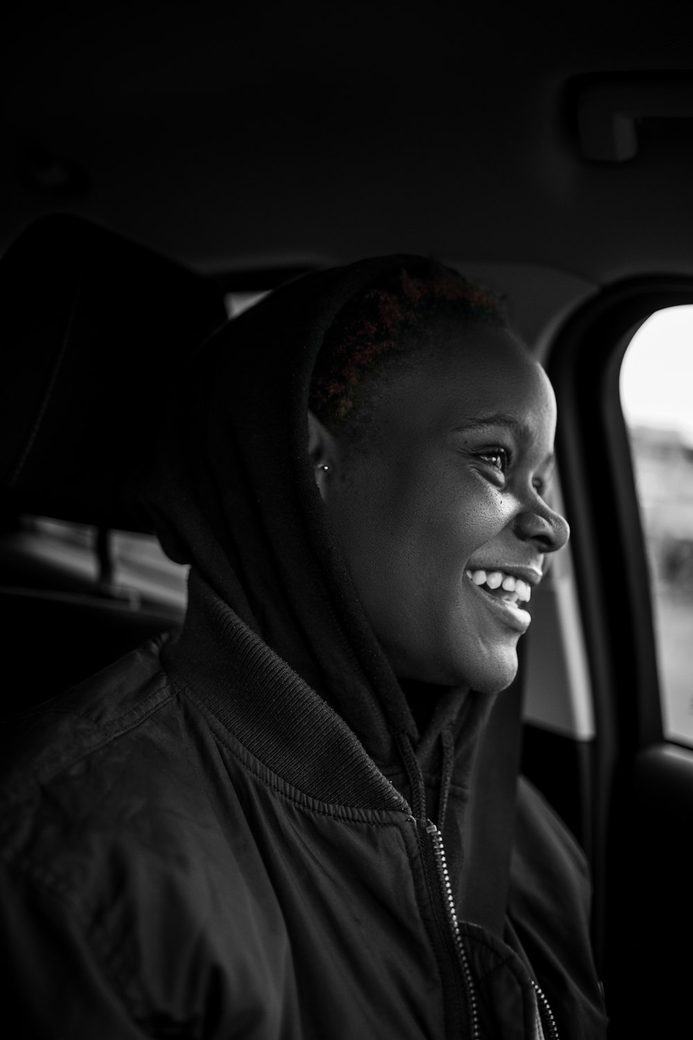 a woman sitting in the passenger seat of a car