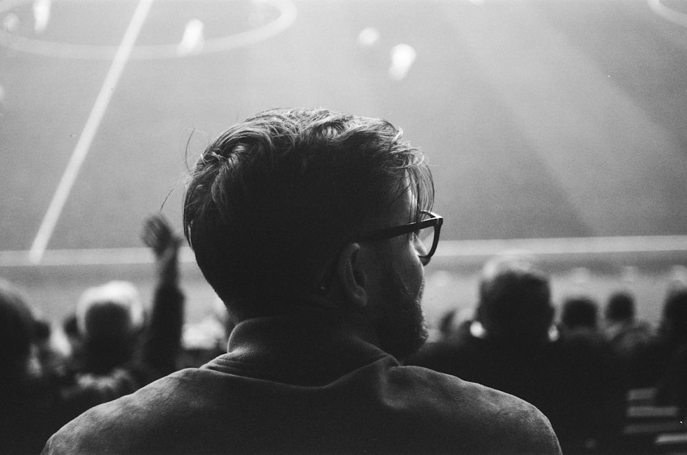 a black and white photo of a man at a soccer game