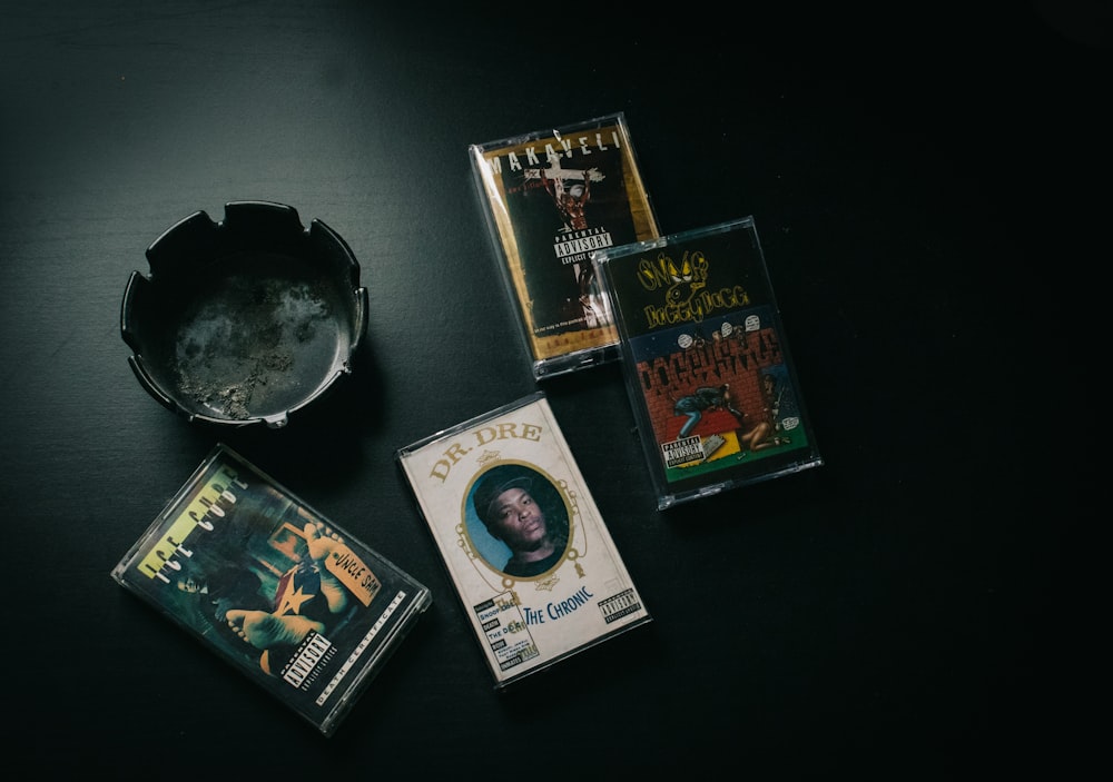 a black table topped with three dvds and a bowl