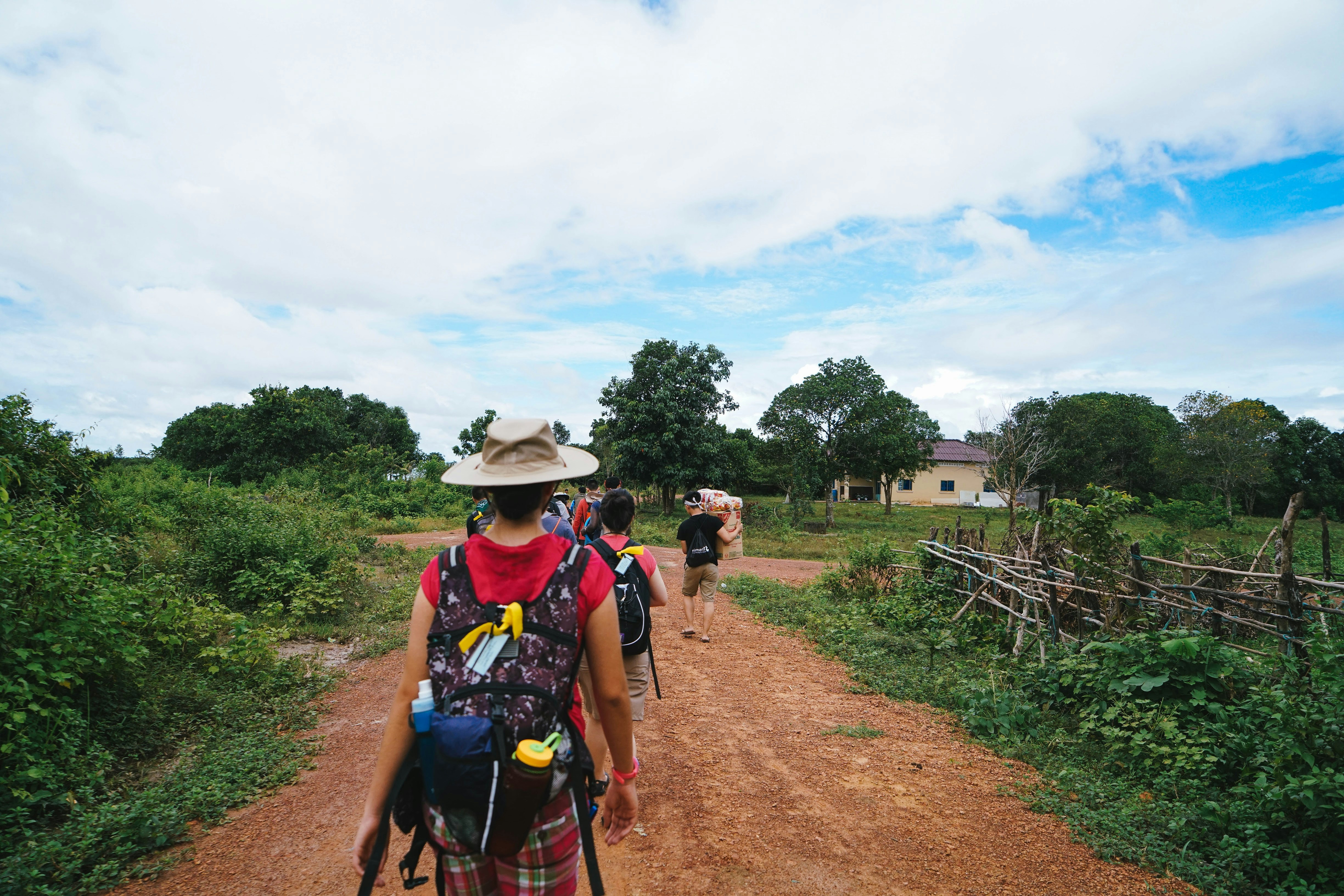 a man riding a bike down a dirt road, 