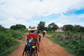 a man riding a bike down a dirt road