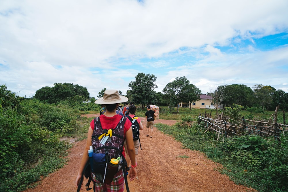 a man riding a bike down a dirt road