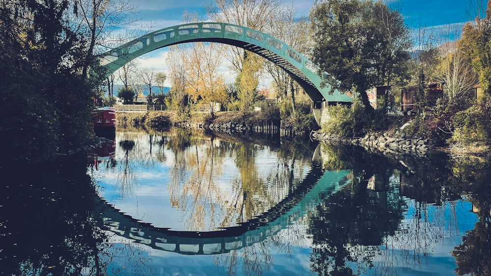 a train crossing a bridge over a body of water