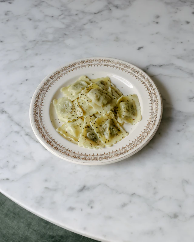 Plate of ravioli on marble