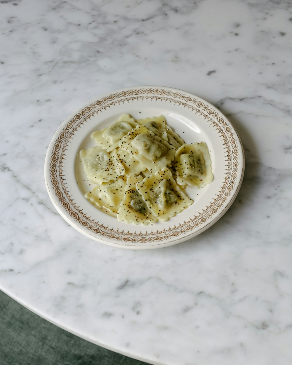 Plate of ravioli on a marble table