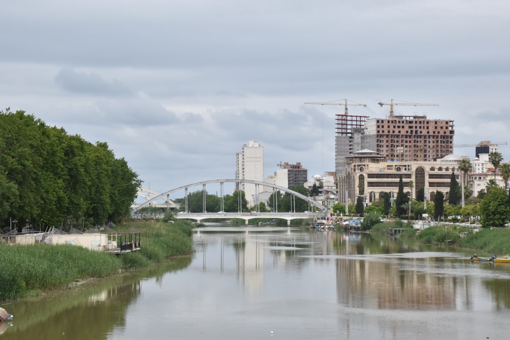 a body of water with a bridge in the background