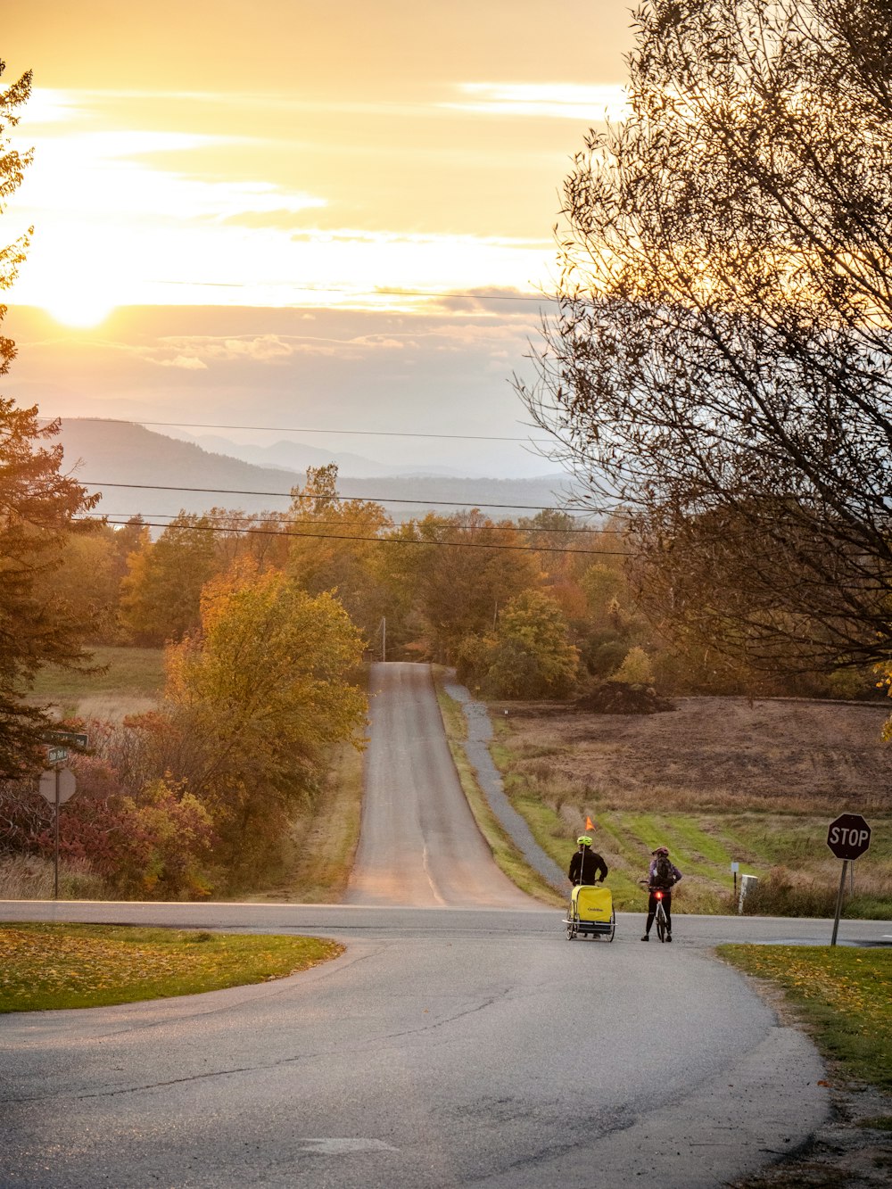 a couple of people standing on the side of a road