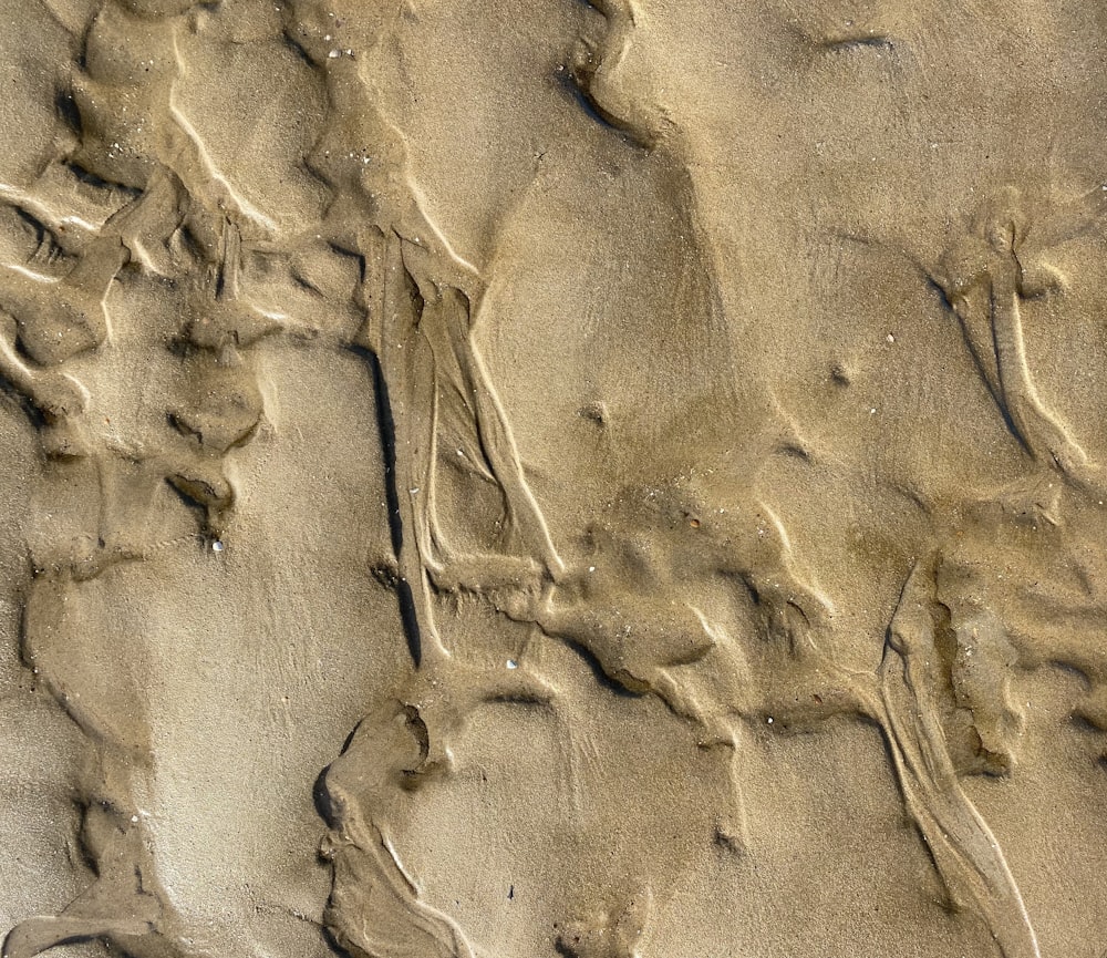 a close up of sand and water on a beach