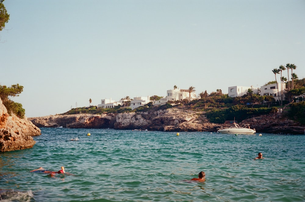 a group of people swimming in a body of water