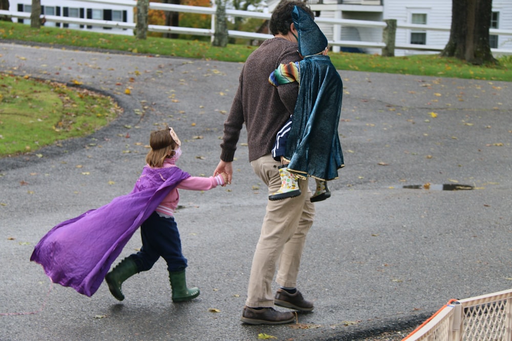 a man and a little girl holding hands