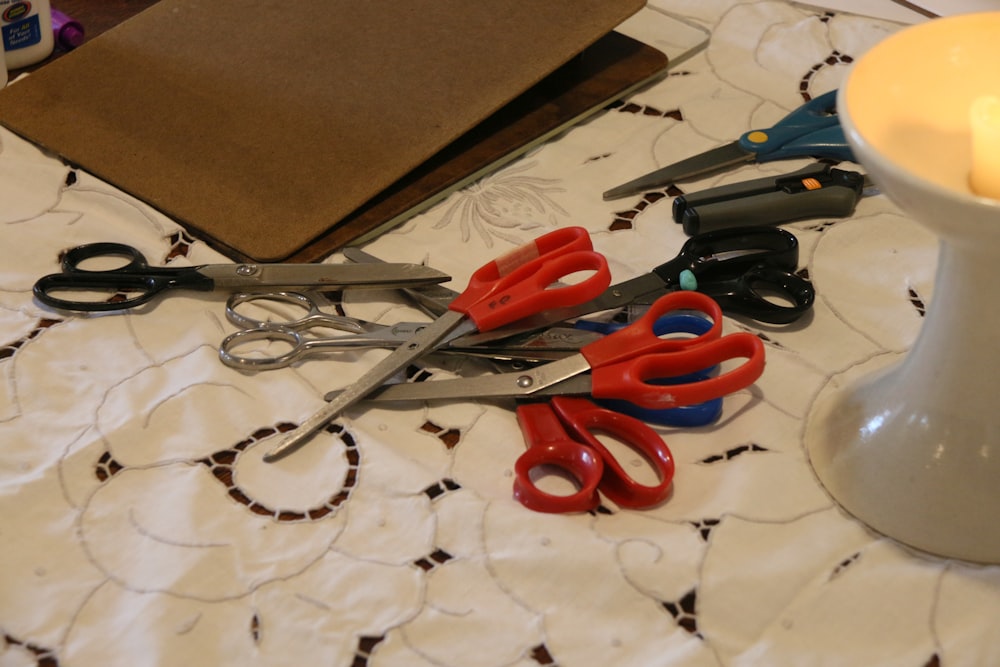 a table topped with scissors and a candle