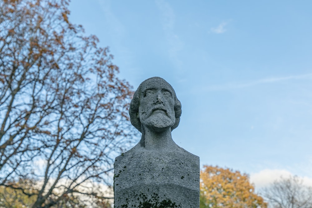 Une statue d’un homme avec une barbe dans un parc