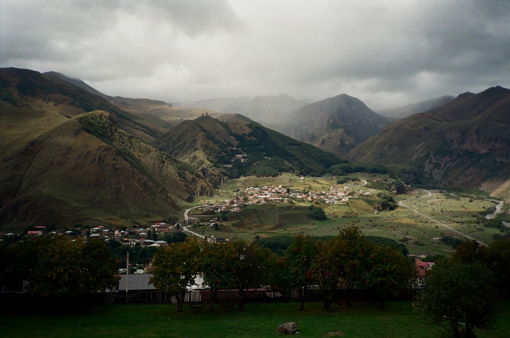 a view of a valley with a village in the distance