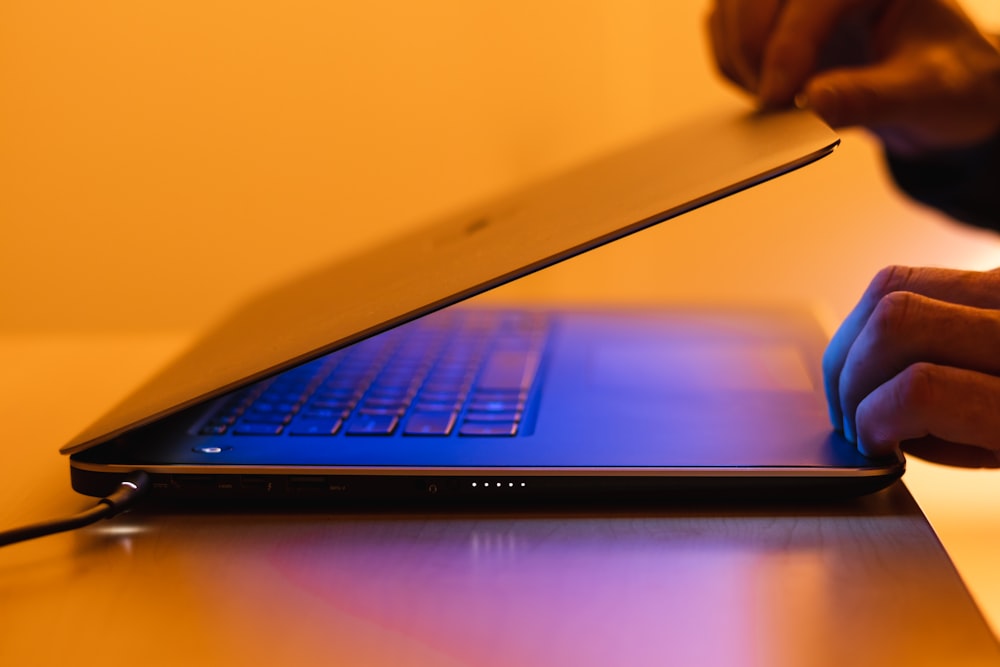 a person using a laptop computer on a desk