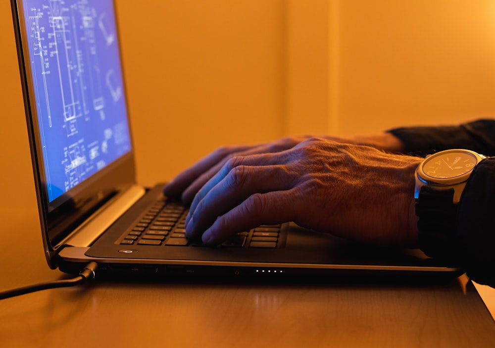 a person using a laptop computer on a desk