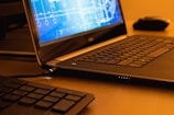 a laptop computer sitting on top of a wooden desk