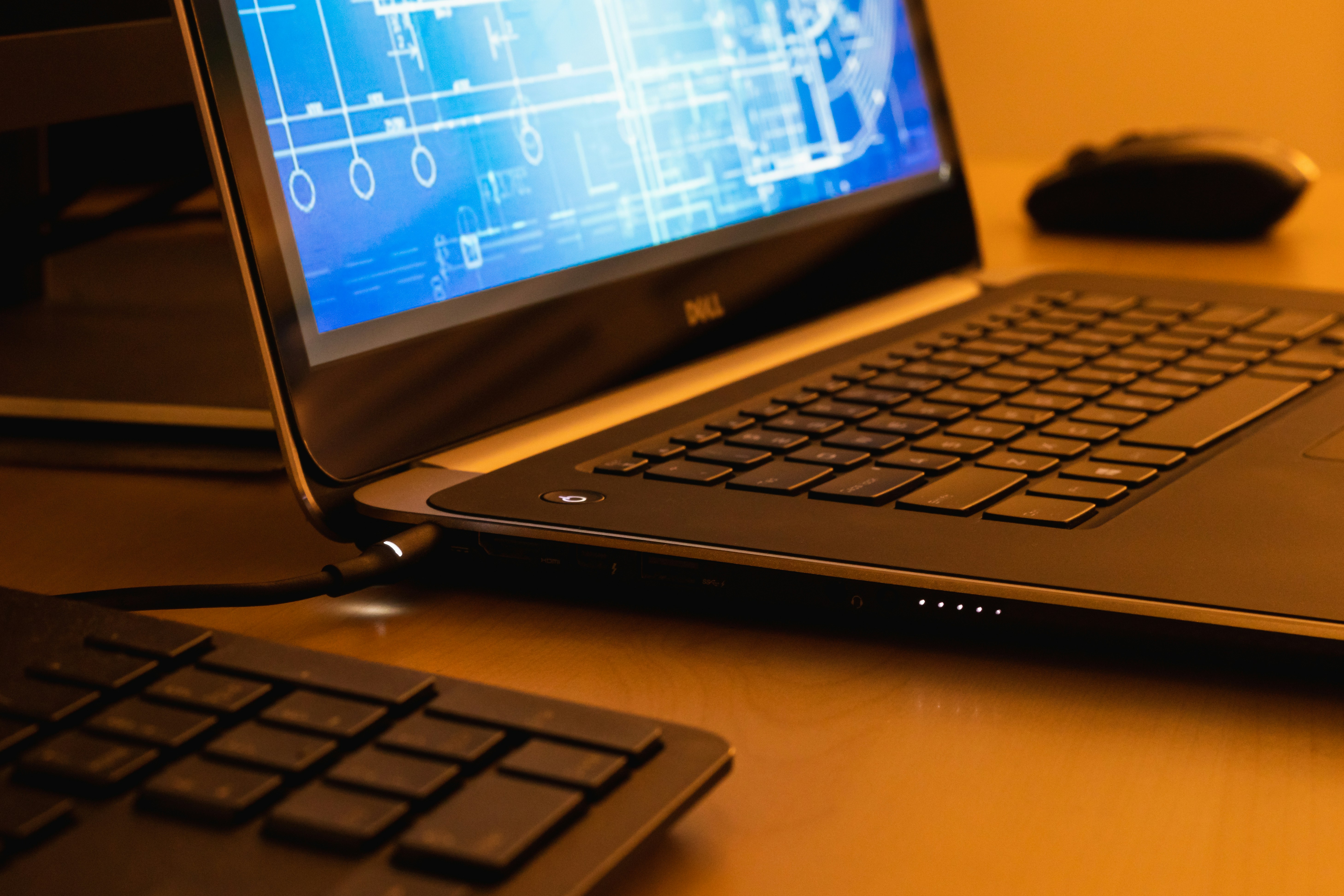 laptop screen displaying pdf editing software with side menu and document preview on workplace desk