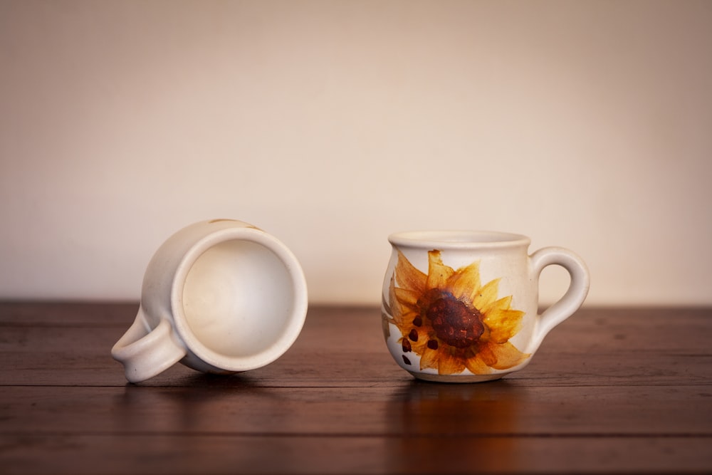 a coffee cup with a sunflower painted on it