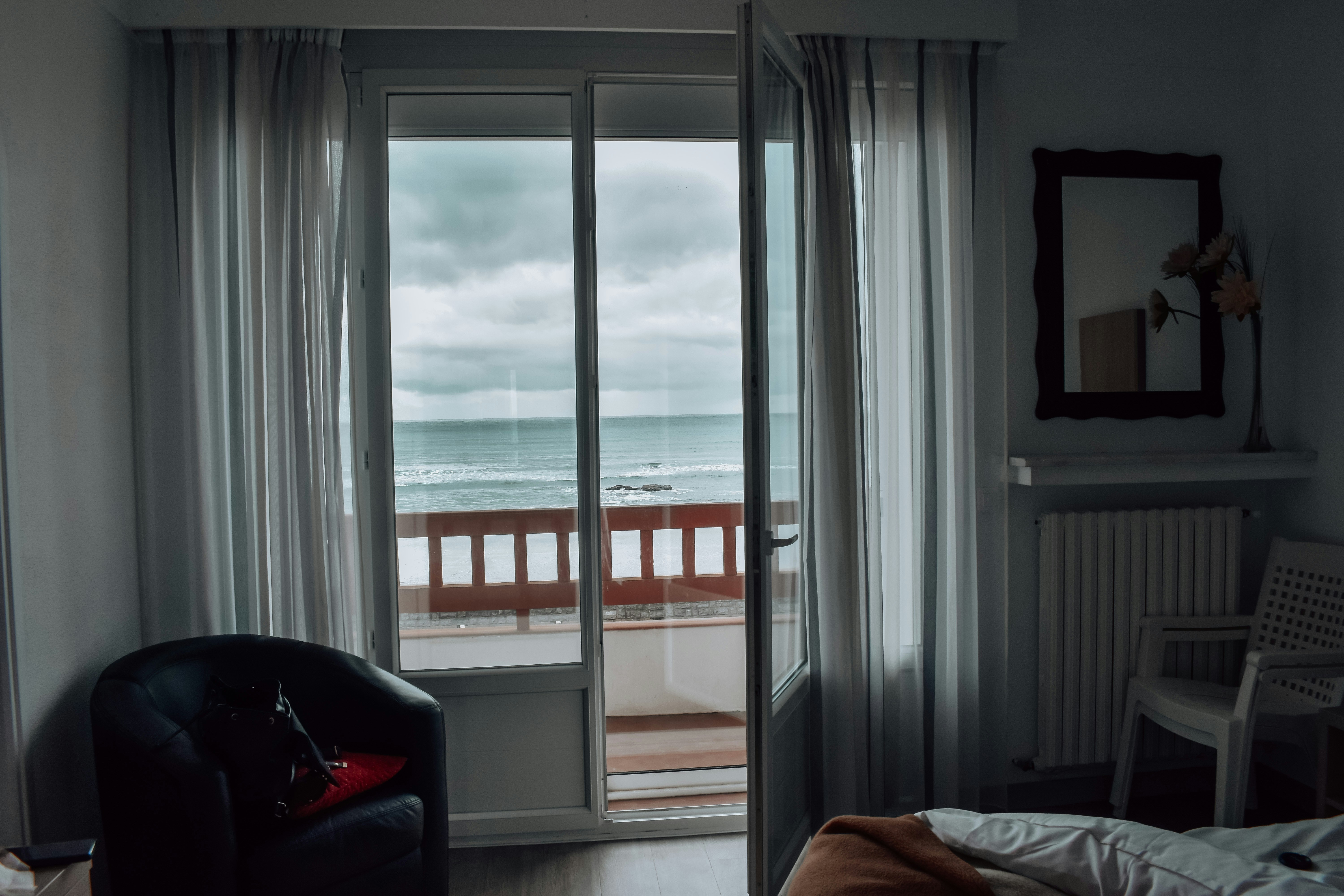 a bedroom with a sliding glass door leading to a balcony