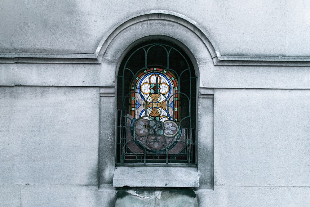 a stained glass window on the side of a building