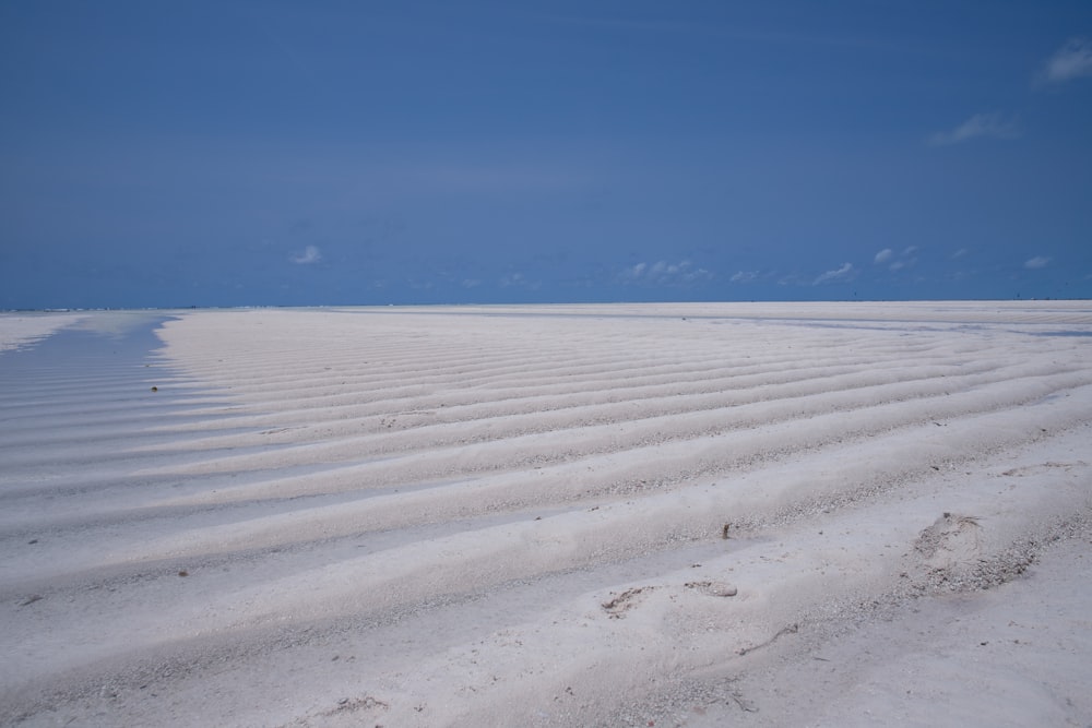 a vast expanse of white sand on a beach
