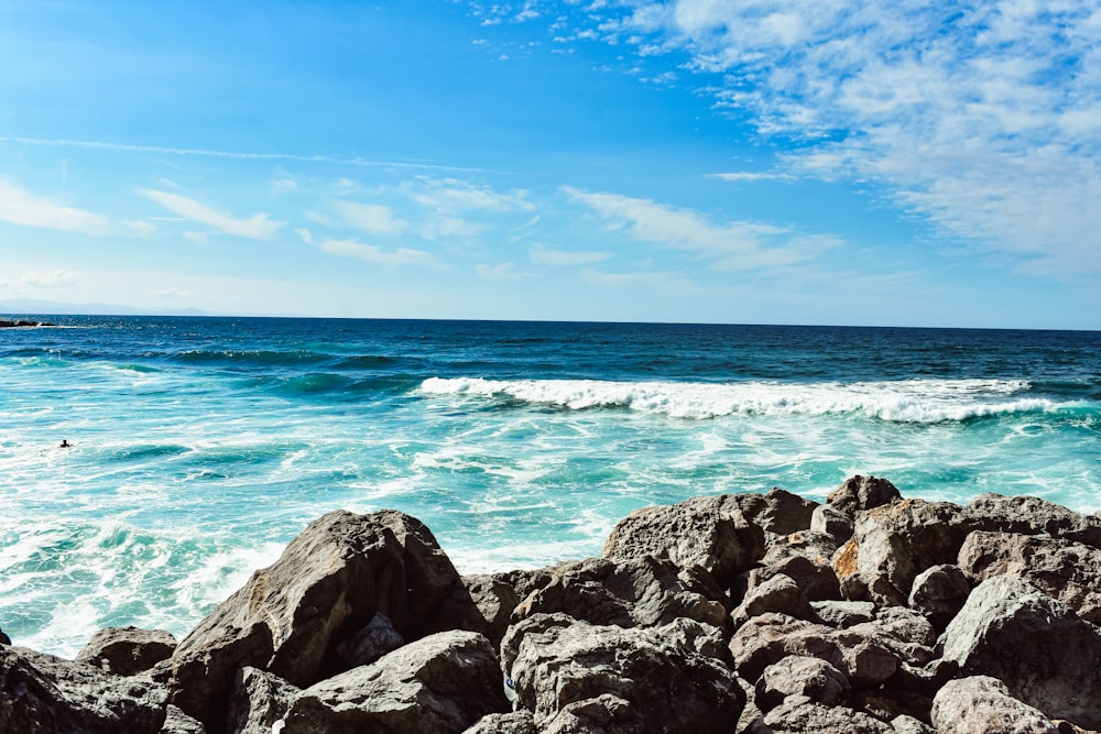 a view of the ocean from a rocky shore