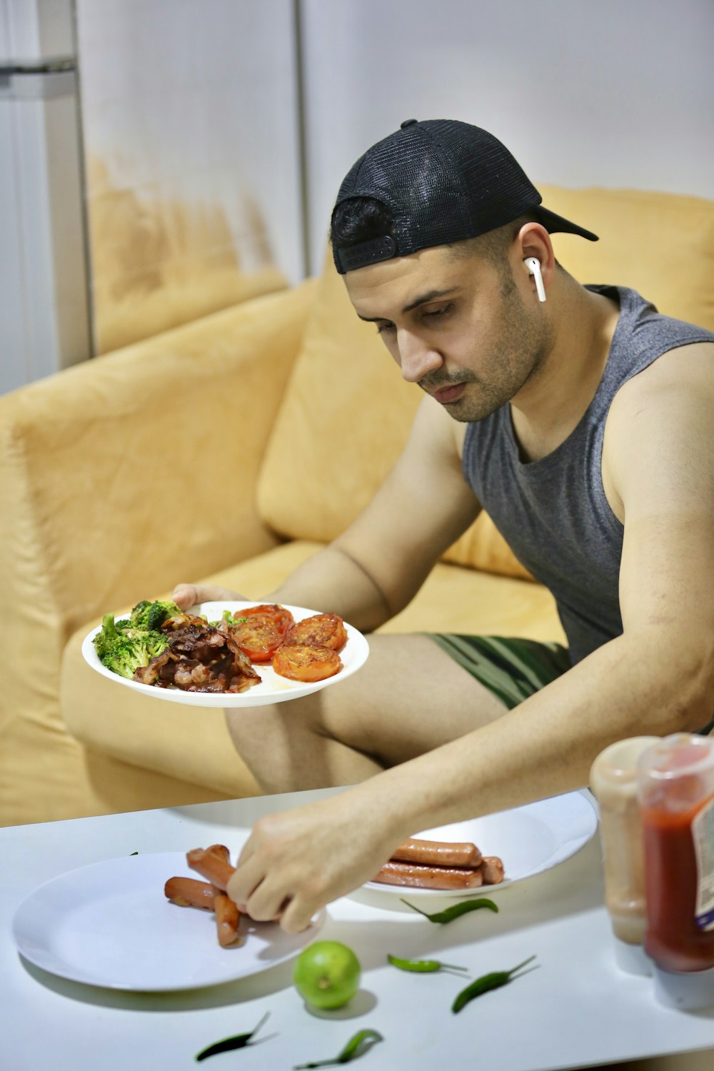 a man sitting at a table with a plate of food