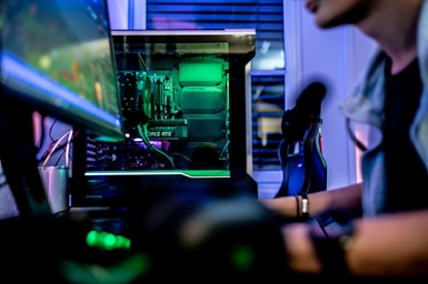 a man sitting in front of a computer monitor