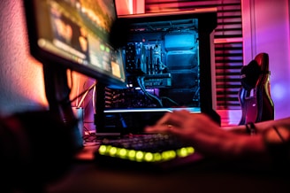 a person sitting in front of a computer monitor