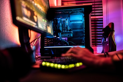 a person sitting in front of a computer monitor