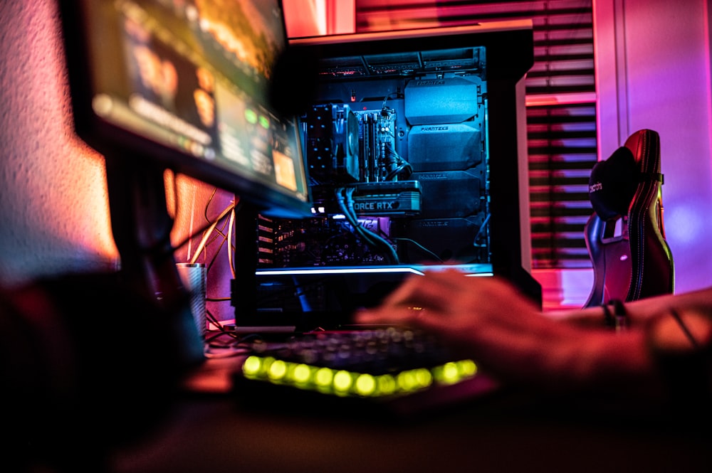 a person sitting in front of a computer monitor