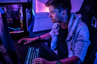a man sitting in front of a computer keyboard
