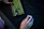Close-up of a gamer’s hands on a glowing neon green keyboard and mouse with a dark futuristic background.