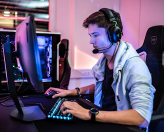 a man wearing a headset and using a computer