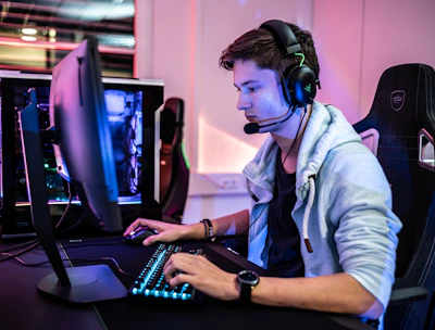 a man wearing a headset and using a computer