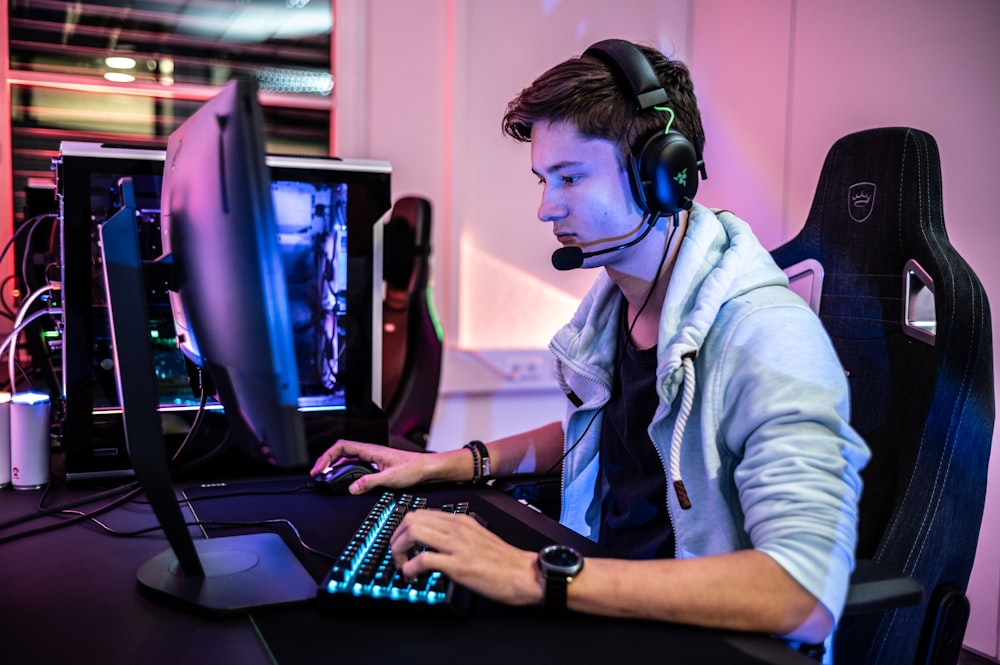 a man wearing a headset and using a computer