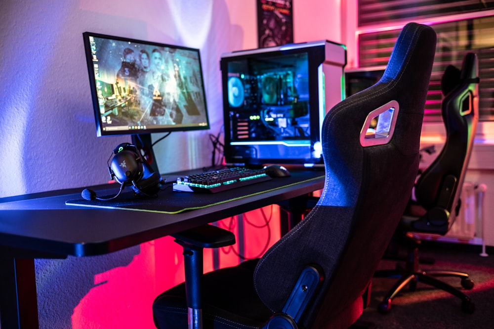 a computer desk with two monitors and a keyboard