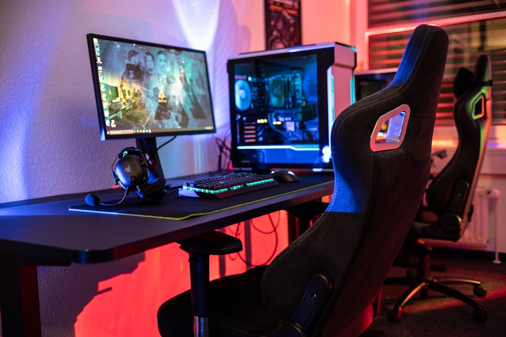 a desk with a computer and a gaming chair