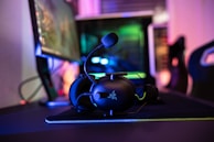 a desk with a computer and headphones on it