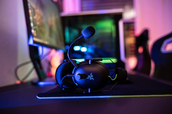 a desk with a computer and headphones on it