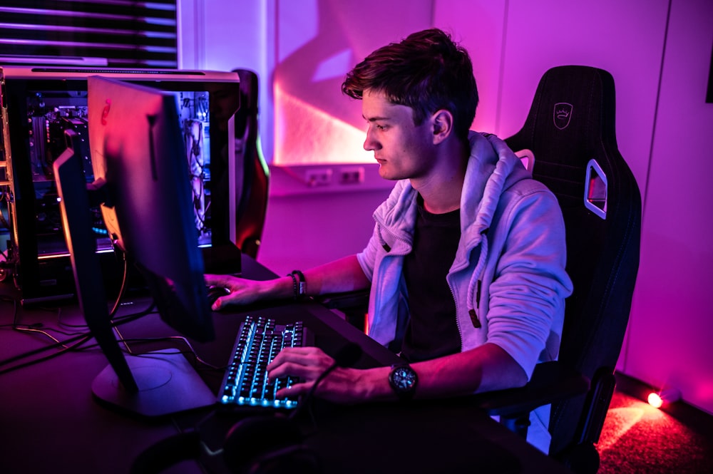 a man sitting in front of a computer keyboard