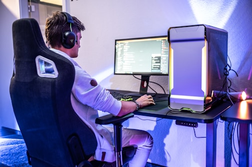 a man sitting in front of a computer on a desk