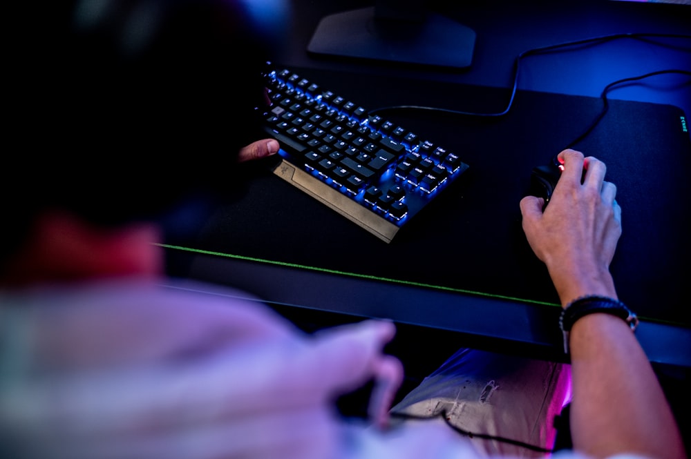 a person is typing on a computer keyboard