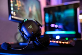 a close up of a mouse and headphones on a desk