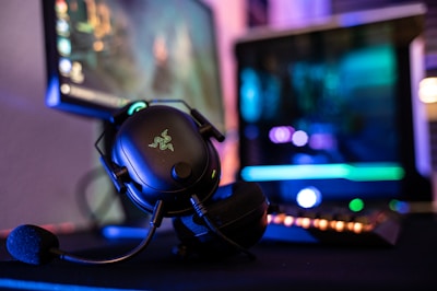 a close up of a mouse and headphones on a desk