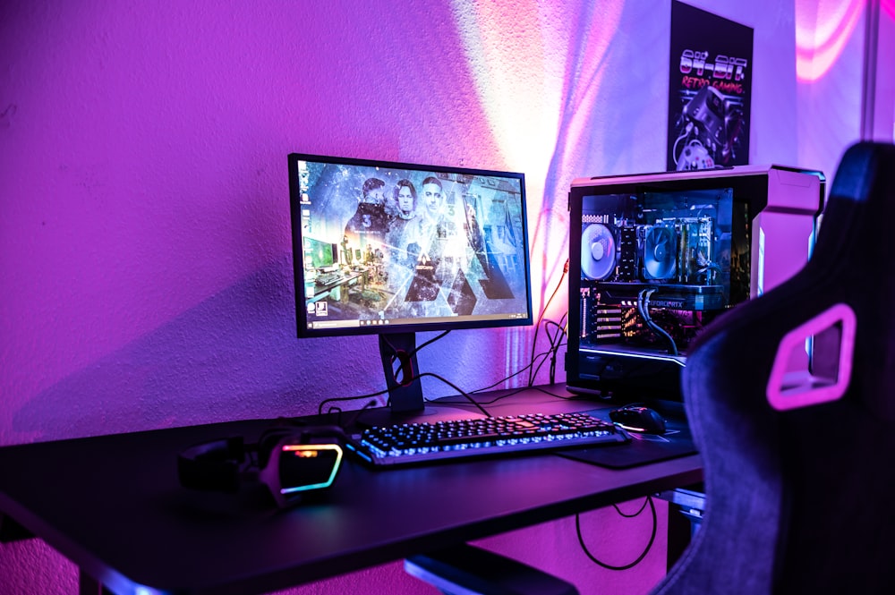 a desk with a computer and a gaming chair