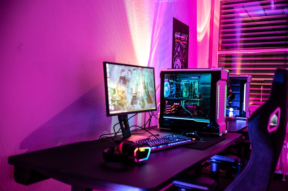 a computer desk with two monitors and a keyboard