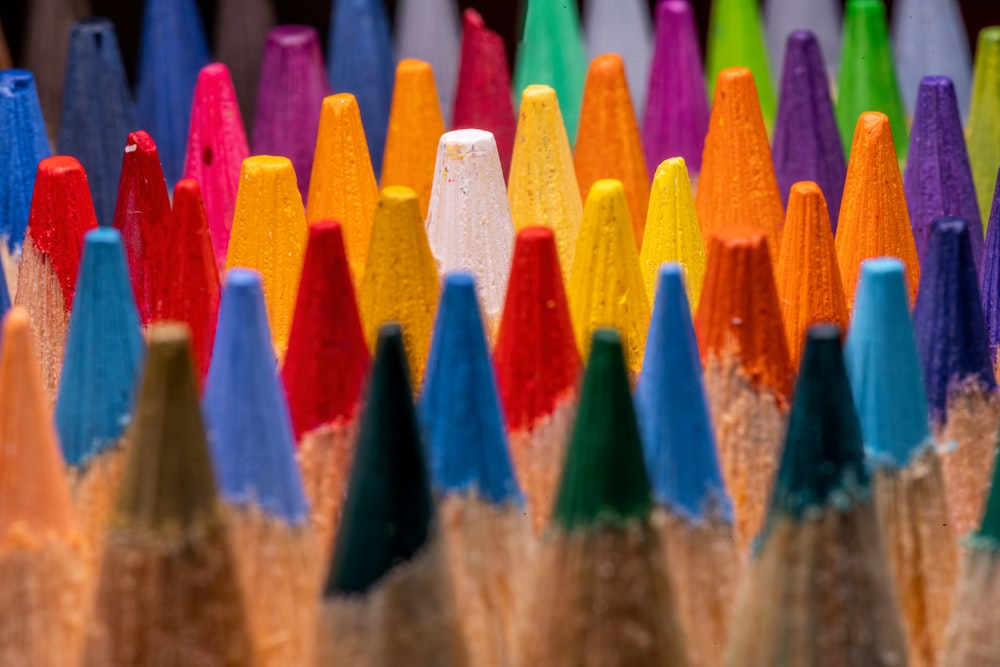 a group of colored pencils sitting next to each other