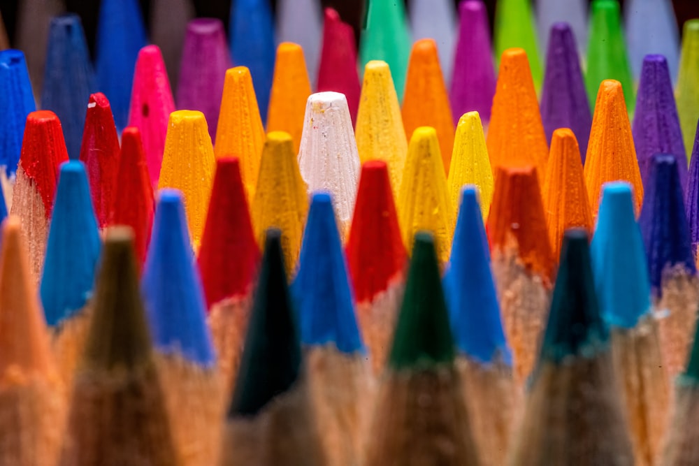 a group of colored pencils sitting next to each other