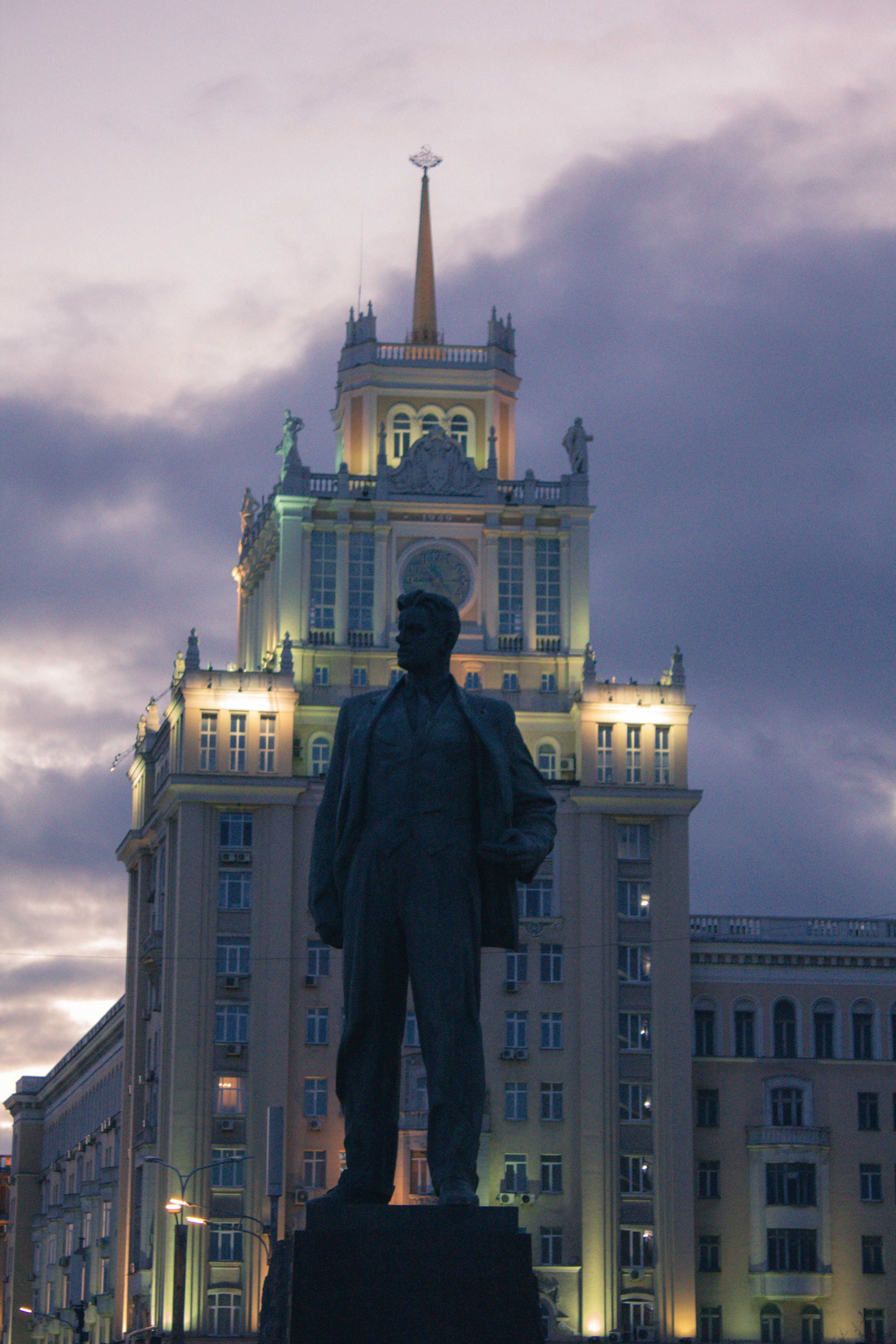 a statue of a man in front of a building